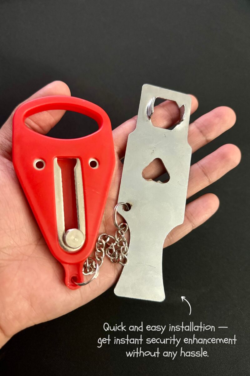 Red and silver portable door lock held in a hand